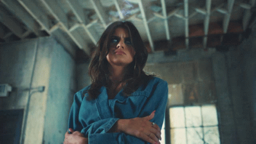 Woman In Blue Shirt With Exit Sign GIF