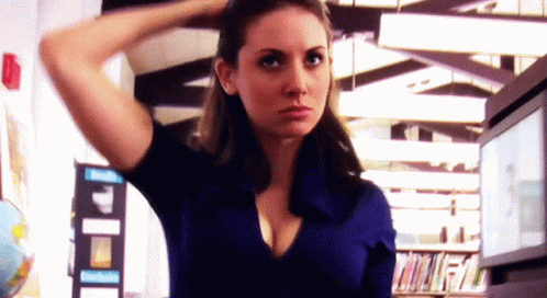 Woman In Blue Shirt With Hand In Hair Library GIF