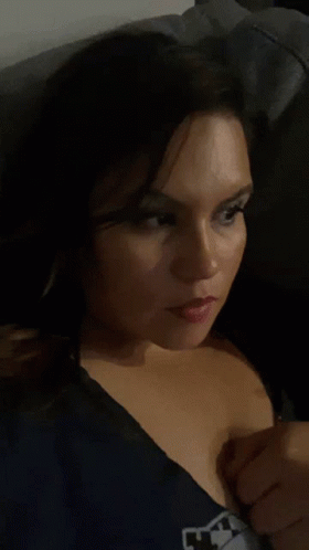 Woman In Blue Shirt With M Taking Selfie GIF