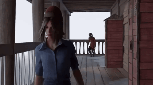 Woman In Blue Shirt With Man In Red Coat On Porch GIF
