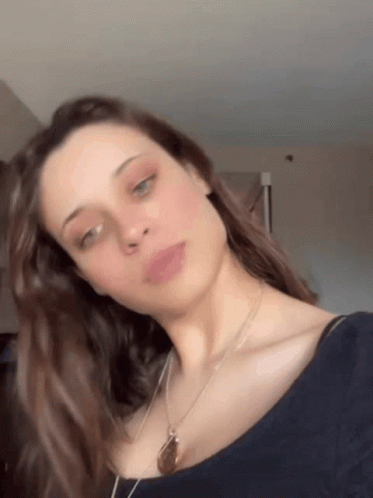 Woman in Blue Shirt With Necklace
