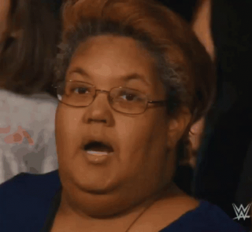 Woman in Blue Shirt with Wrestling Logo