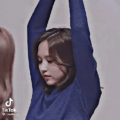 Woman in Blue Sweater Dancing with Microphone