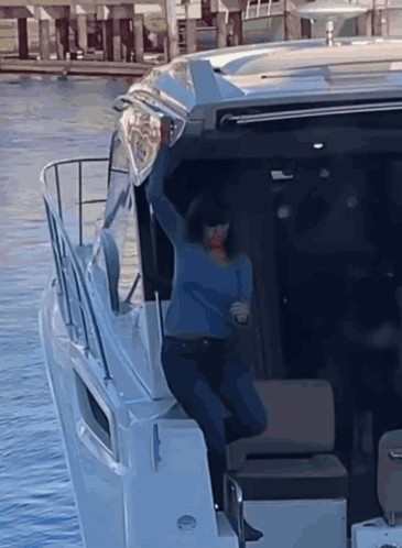 Woman in Blue Sweater Standing on Boat