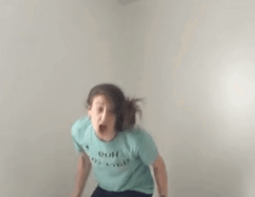 Woman in Blue T-Shirt Jumping