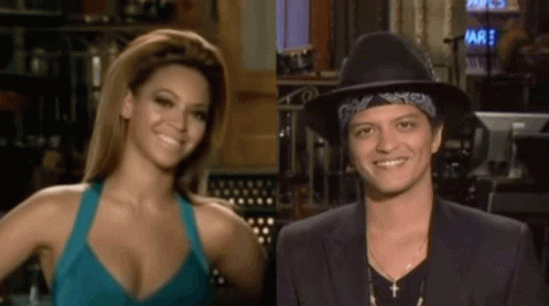 Woman in Blue Tank Top and Man in Black Hat Smiling