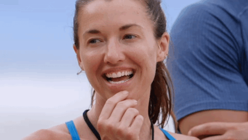 Woman in Blue Tank Top Smiling Hand to Chin