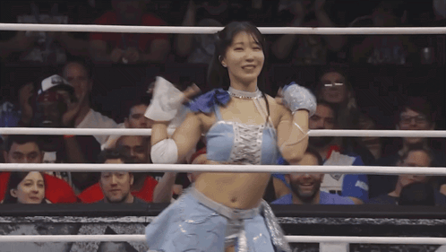 Woman in Blue Top and Silver Skirt Boxing Ring