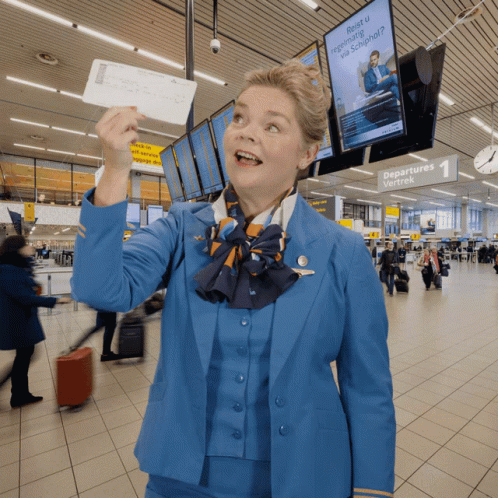 Woman in Blue Uniform Holding Ticket at Departures Wachtek