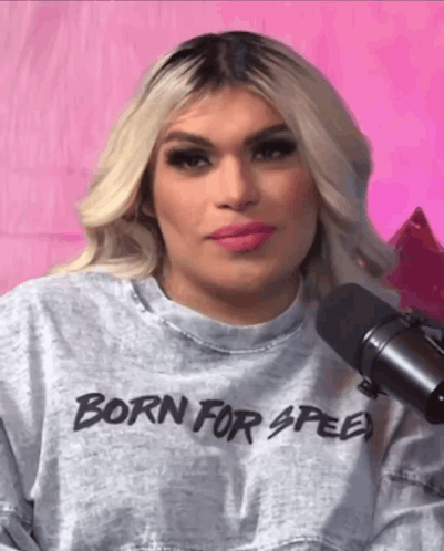 Woman in Born for Speed Sweatshirt at Microphone