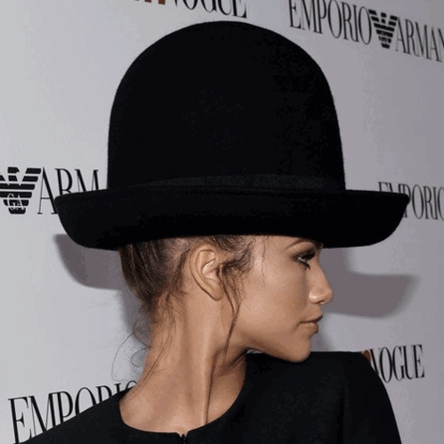 Woman in Bowler Hat in Front of Emporio Armani Sign