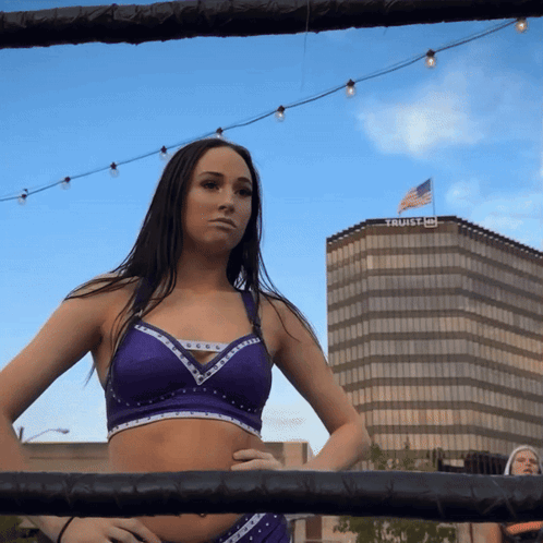 Woman in Boxing Ring in Front of Trust Building