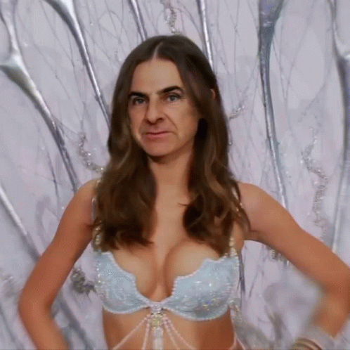 Woman in Bra With Man Behind Her