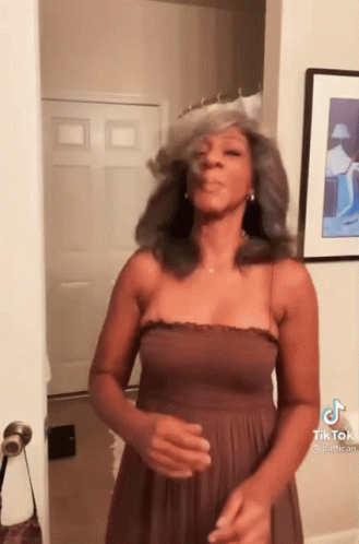 Woman in Brown Dress Making Funny Face at Door