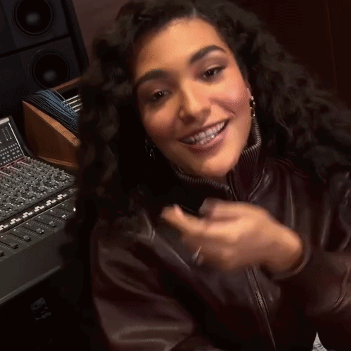 Woman In Brown Leather Jacket Smiling And Clapping GIF