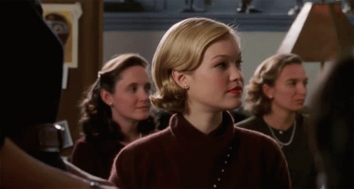 Woman in Brown Sweater Standing in Line With Others