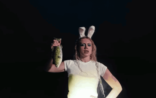 Woman in Bunny Ears Holding Fish