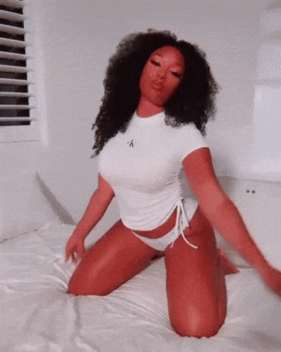 Woman in Calvin Klein Shirt Kneeling on Bed
