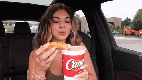 Woman in Car Eating Chicken Nugget Drinking Cane Soda