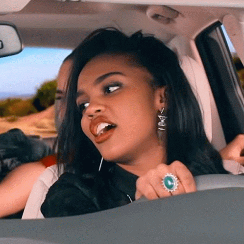 Woman in Car With Ring Saying X