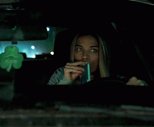 Woman in Car With Shamrock Hanging From Rear View Mirror