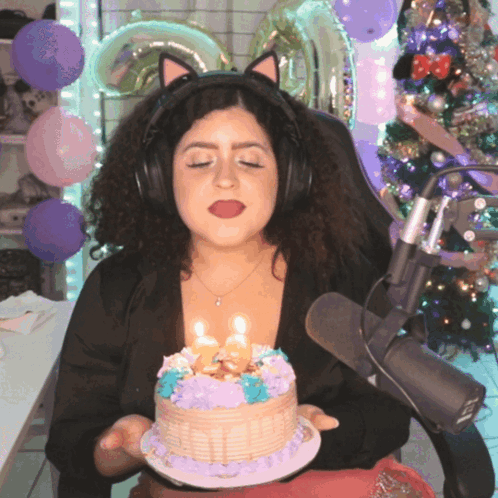 Woman in Cat Ears Holding Cake With Candles