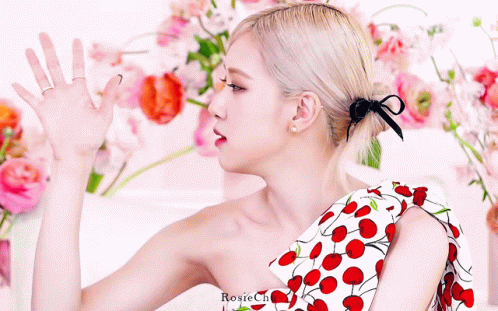 Woman In Cherry Dress Standing In Flowers GIF