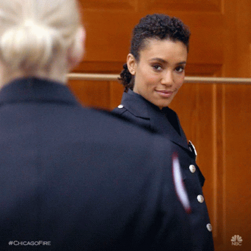 Woman in Chicago Fire Uniform Smiling at Another