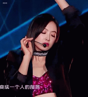 Woman in Choker with Microphone Saying Reve
