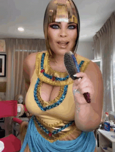 Woman in Cleopatra Costume Brushing Hair