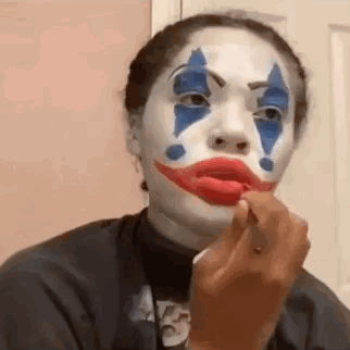 Woman in Clown Costume Applying Lipstick