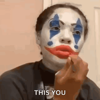 Woman in Clown Makeup Applying Red Lipstick