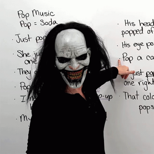 Woman In Clown Mask Pointing To Pop Music List GIF
