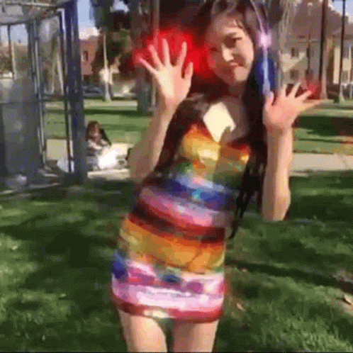 Woman in Colorful Dress and Headphones in Park
