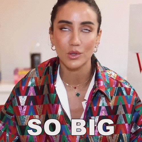 Woman In Colorful Jacket Making Funny Face Saying So Big GIF