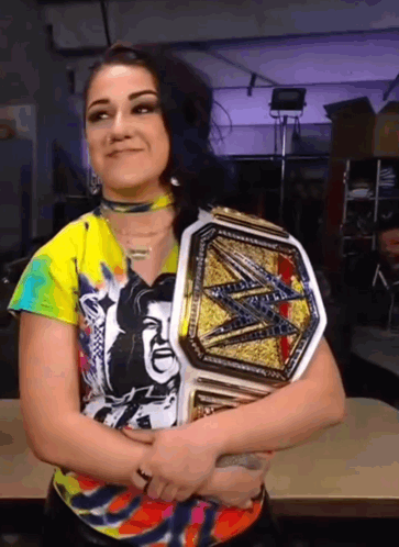 Woman in Colorful Shirt Holding Wrestling Belt