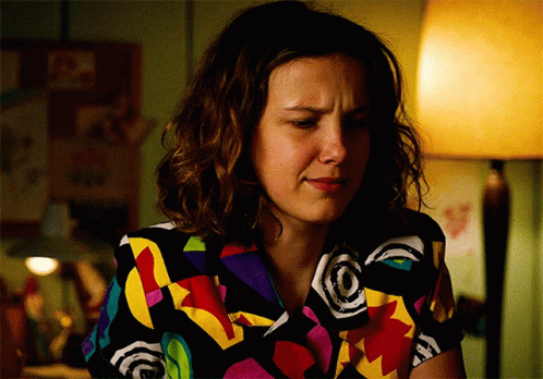 Woman in Colorful Shirt Sitting with Lamp