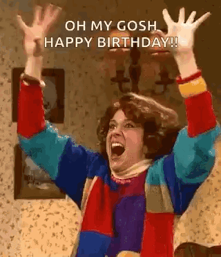 Woman in Colorful Sweater Raising Arms