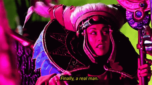 Woman in Costume Holding Sword Saying Finally a Real Man