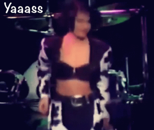 Woman in Cow Print Crop Top Dancing in Front of Drum Set