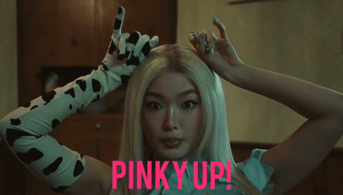 Woman in Cow Print Gloves Pinky Up