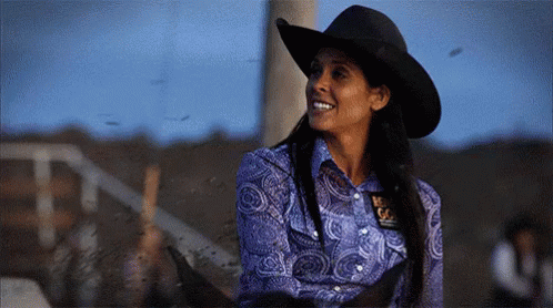Woman in Cowboy Hat and Blue Shirt With Texas Badge