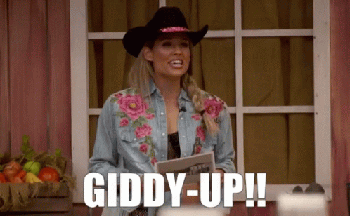 Woman in Cowboy Hat and Denim Shirt Says Giddy Up
