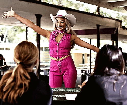 Woman In Cowboy Hat And Pink Pants With Group Of Women GIF