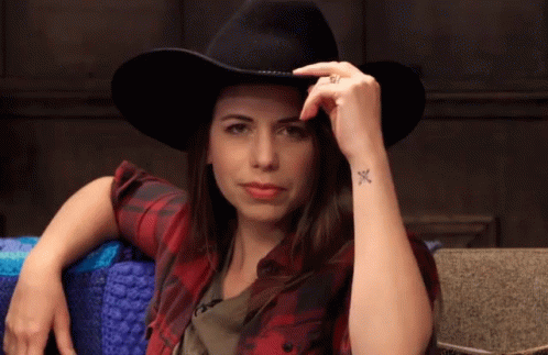 Woman in Cowboy Hat and Plaid Shirt With Wrist Tattoo