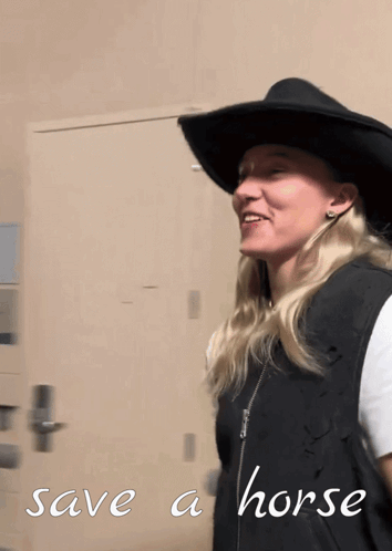 Woman in Cowboy Hat and Vest Saying Save a Horse