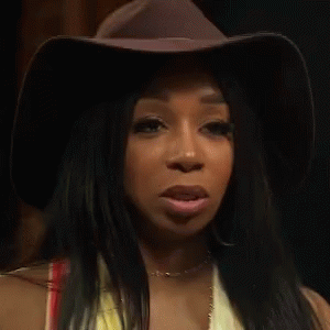 Woman In Cowboy Hat And Yellow Top Making A Face GIF