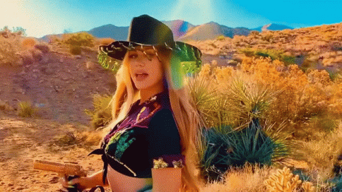 Woman in Cowboy Hat Holding Gun