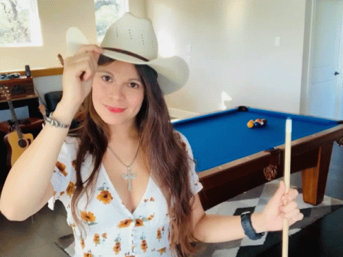 Woman in Cowboy Hat Holding Pool Cue