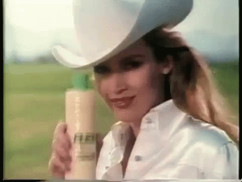 Woman in Cowboy Hat Holding Shampoo